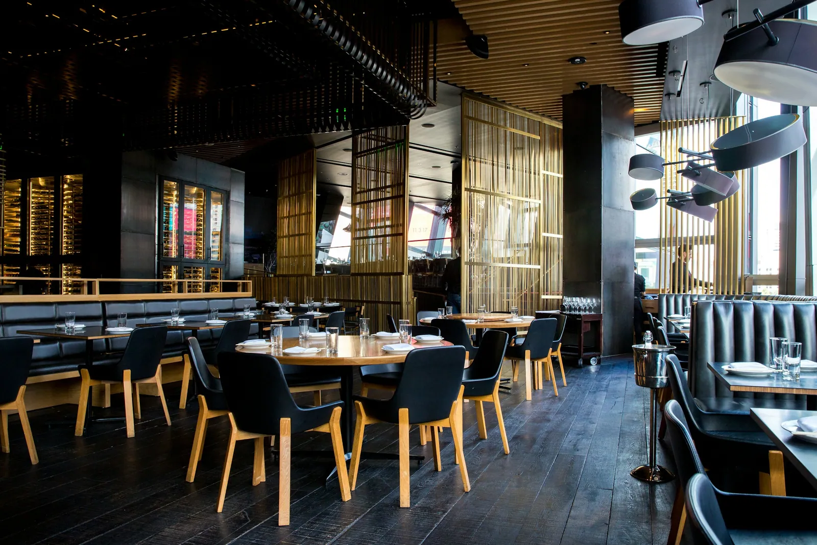 A modern restaurant dining room set for an evening service